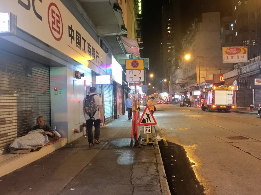 Homeless man on the Queen's Road West road, Hong Kong