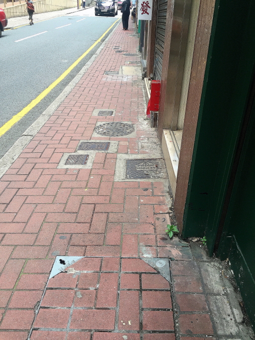 Manhole on pedestrian walkway, Hong Kong