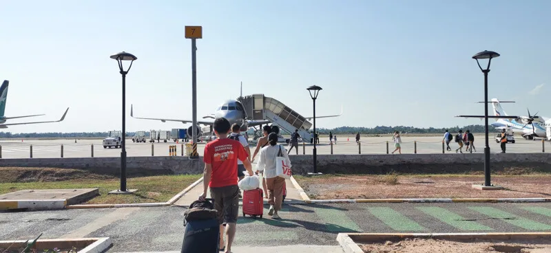 Flying out of Siem Reap Airport - walk across runway to the plane