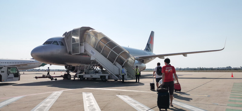 Flying out of Siem Reap Airport - walk across runway to the plane